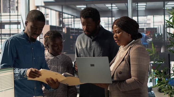 Colleagues reviewing work together in an office