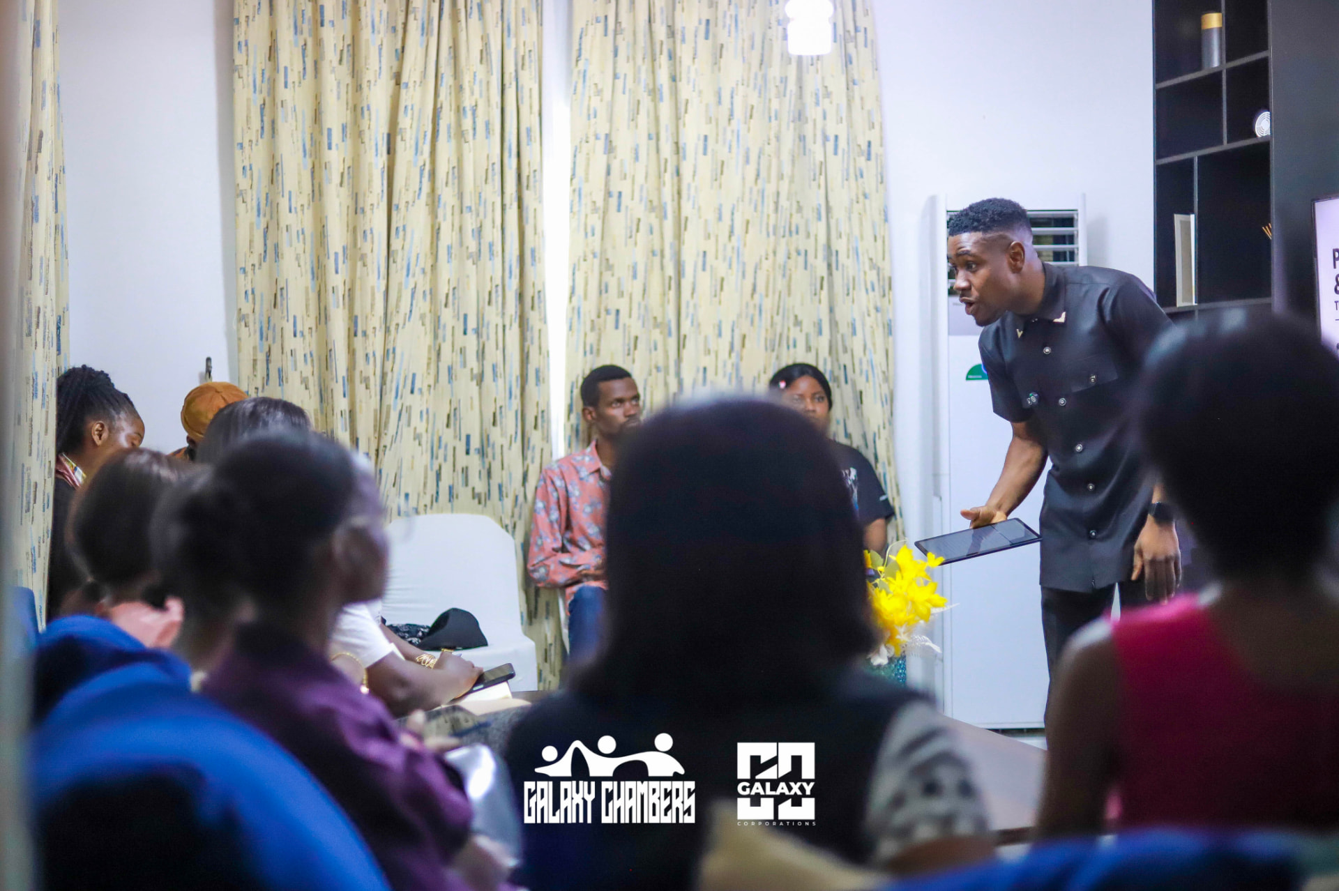 Facilitator engaging the audience with a tablet